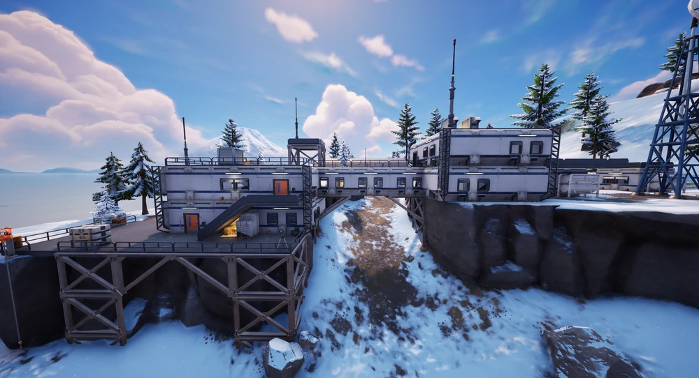 The outside of the Lakeside Lab, a long white building raised on a timber pier above snowy rock