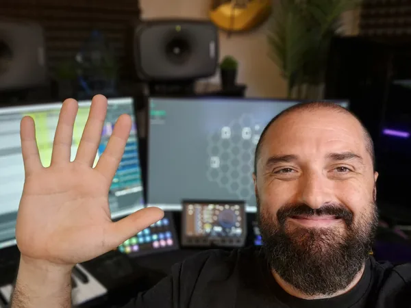 Joe Hudson waving hello from his studio